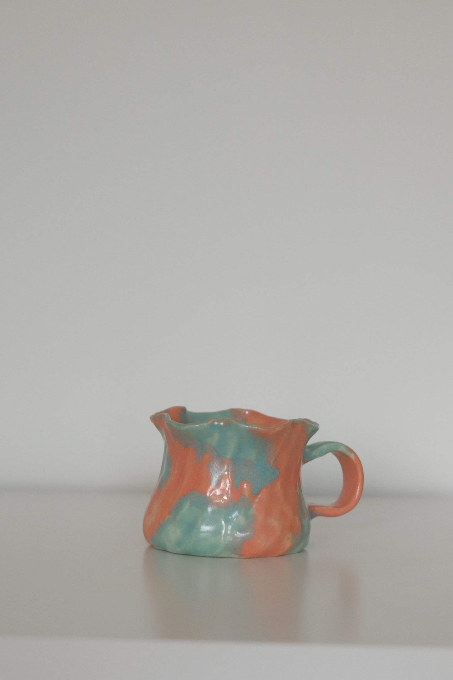 Ruffle Rim Mug in Blood Orange & Lime shown from a side angle