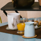 Blue La Rochère Bee ceramic coffee mug on a kitchen table