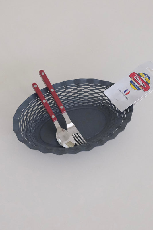 Gray woven artisan bread basket on table with rolls