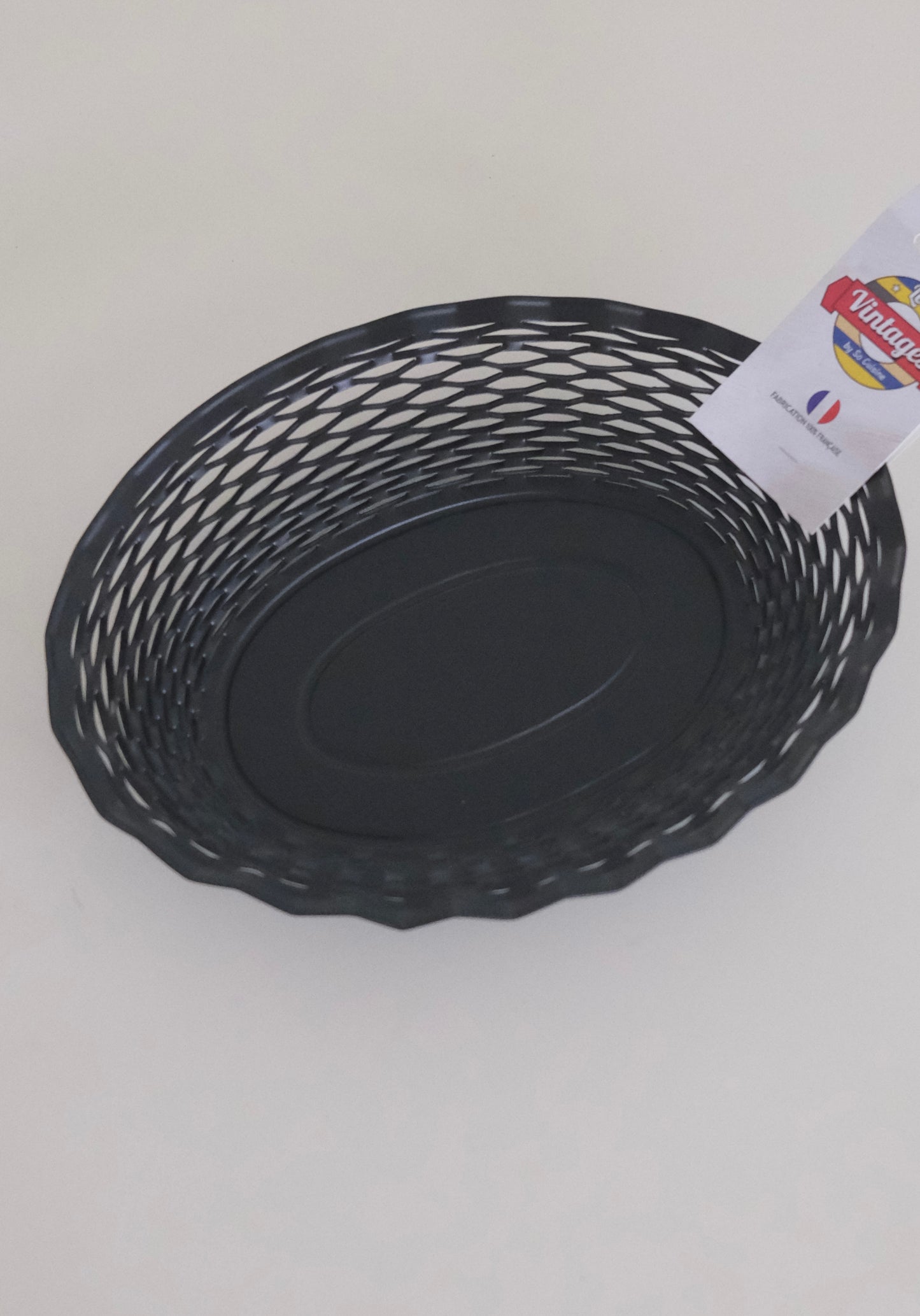 Matte black woven artisan bread basket on table