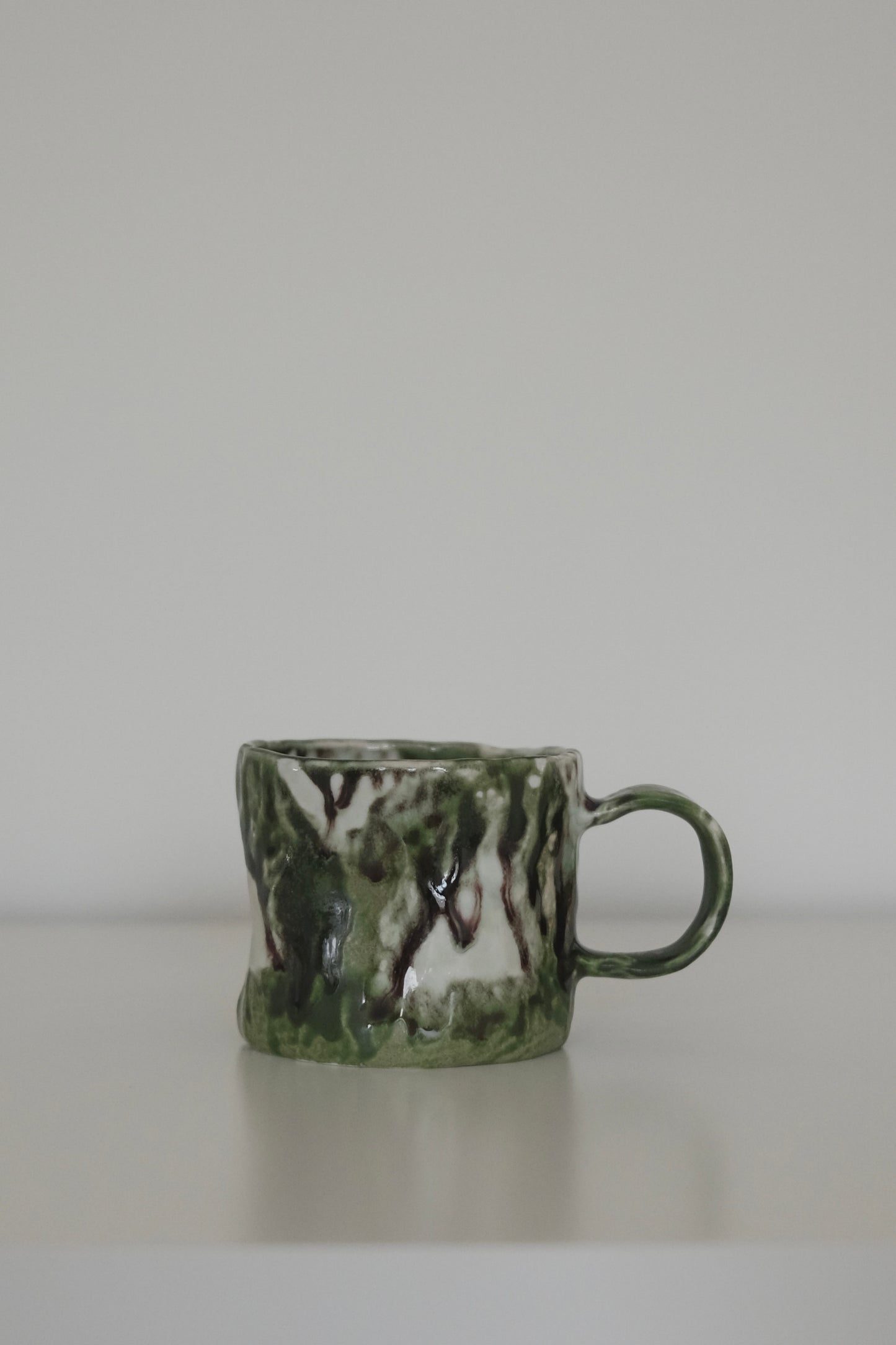 Close-up of matcha green mug rim and glaze texture