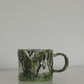 Matcha mug styled with coffee on a kitchen counter