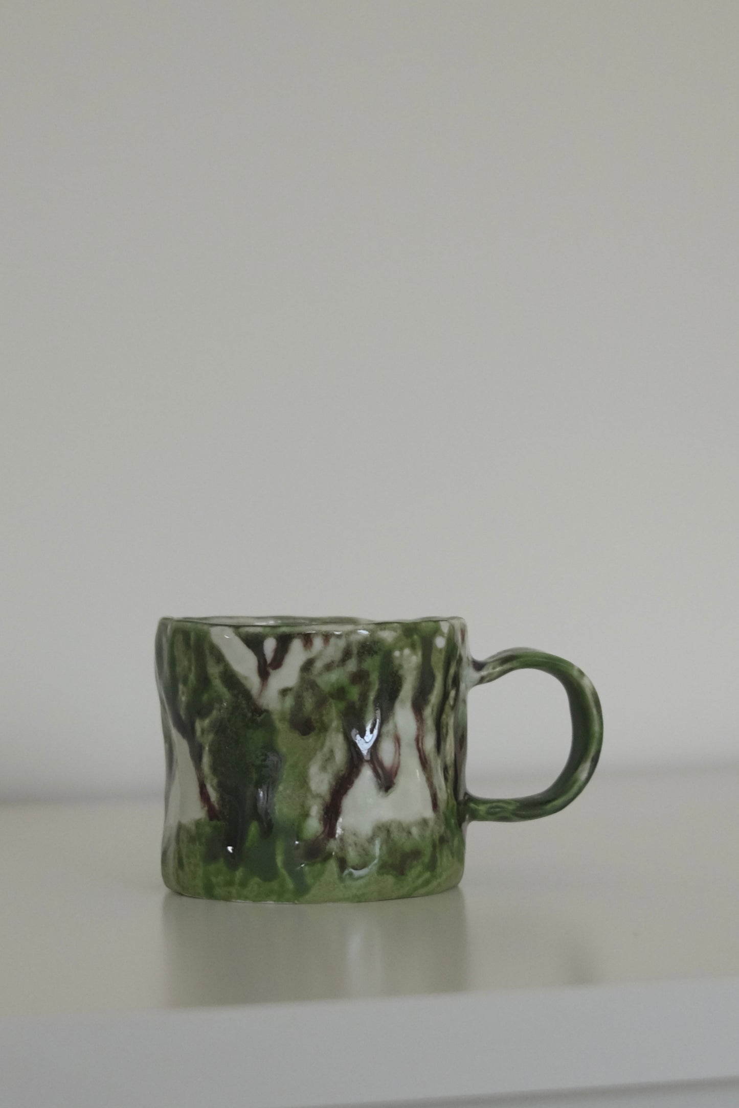 Matcha mug styled with coffee on a kitchen counter