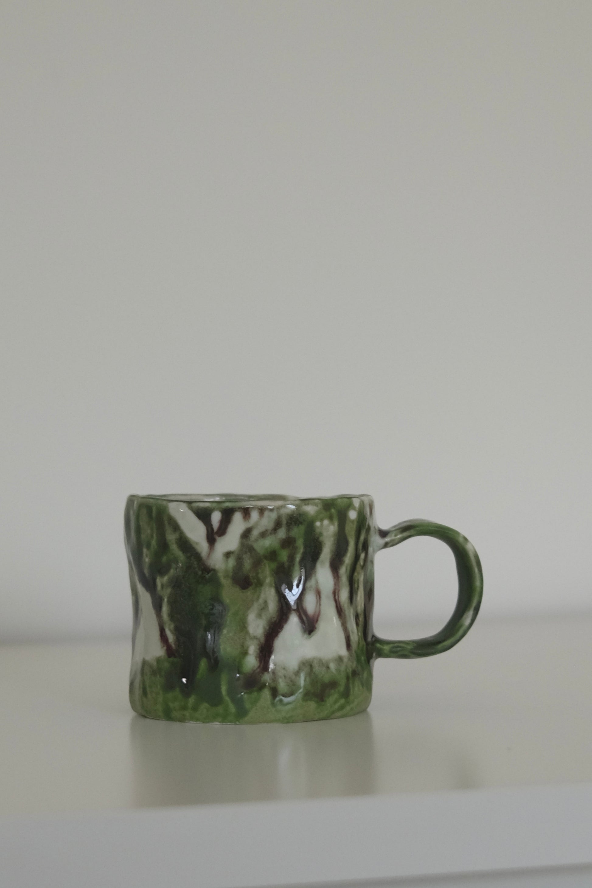 Matcha mug styled with coffee on a kitchen counter