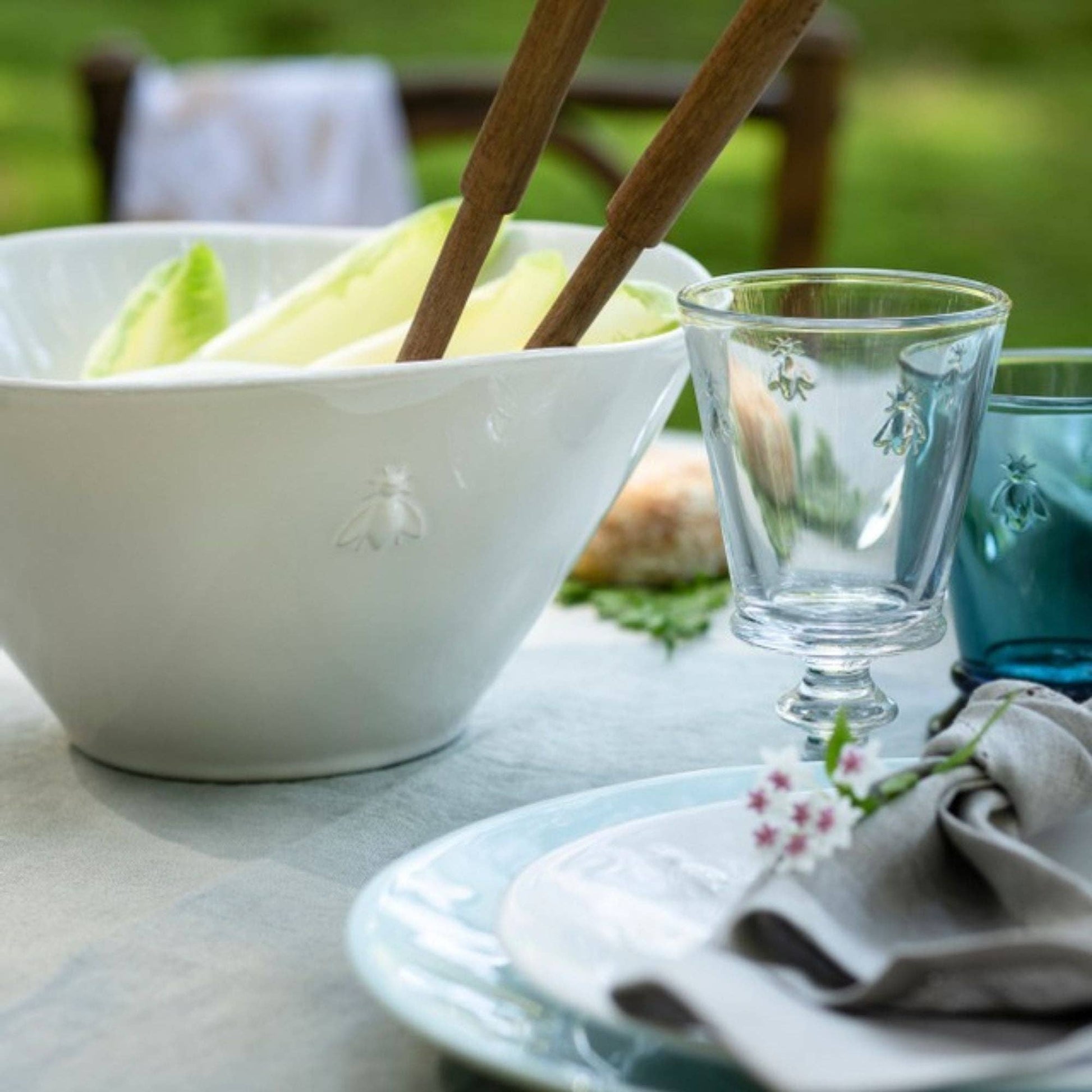 La Rochère Bee serving bowl filled with salad on a table