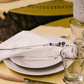 Stacked La Rochère Bee ceramic dinner plates showing the embossed pattern
